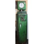 A green painted metal petrol pump, the white circular dial inscribed 'John B.