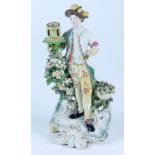 An 18th century English porcelain figure of a courtier,