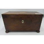 A George III mahogany tea caddy with two compartments flanking a central glass bowl, on bun feet,