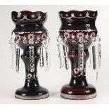 A pair of ruby glass lustres, height 37cm, diameter of top 16.8cm.