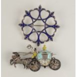 A silver and blue enamel circle brooch and an enamel marcasite set silver carriage brooch.