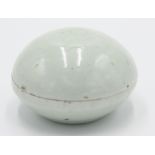 A Bernard Leach porcelain cosmetic box, with celadon glaze, the domed lid with incised flower,