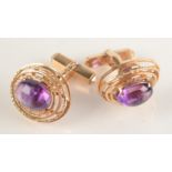 A pair of 14ct gold cufflinks set with amethyst.
