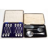 A set of twelve engraved teaspoons and tongues cased,