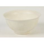 A Chinese white glazed bowl of rounded form with flared rim, height 6cm, diameter 12cm.