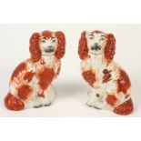 A pair of Victorian Staffordshire spaniels, height 16cm.