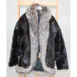 A black saga mink lady's coat with silver fox trim, size 12-16, length 77cm (30inches).