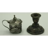 A filled silver low candlestick and a pierced silver mustard pot.