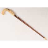 An ivory mounted walking stick, 19th century, with malacca shaft,