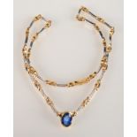 A contemporary 18ct white and yellow gold necklace set with diamonds and navette sapphires,