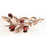 A 9ct gold garnet set spray brooch, 12g.