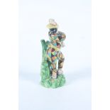 A rare Staffordshire pottery figure of Harlequin masked, early 19th century, height 13.5cm.