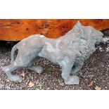 A moulded composition prowling lion, length 107cm.