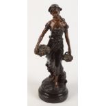 A bronze figure of a lady holding baskets of grapes, height 35cm.