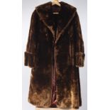 A chocolate brown faux fur lady's coat, with dark brown satin lining, length 125cm, size 12/14.