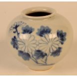 A Japanese blue and white vase, of squat form and decorated with flowering trees, height 7.5cm.