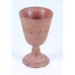 An ancient Roman Samian goblet, the conical bowl with incised wave motif showing signs of colouring,