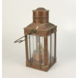 A copper lantern, early 20th century, the swing handle above four glazed panels, height 37cm,