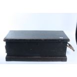 A black painted pine box, circa 1900, height 28cm, width 73cm, depth 33.5cm.