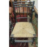An Arts and Crafts ebonised rush seated side chair, height 83cm, width 42cm.