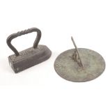 A bronze sundial, diameter 19.7cm and a flat iron.