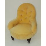 A Victorian yellow upholstered tub armchair, on turned tapering mahogany front legs, height 78cm.