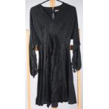 A black dress with subtle geometric pattern, length 94cm, size 8/10.