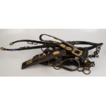 A quantity of horse brasses, leather harnesses including makers and a pair of hames.