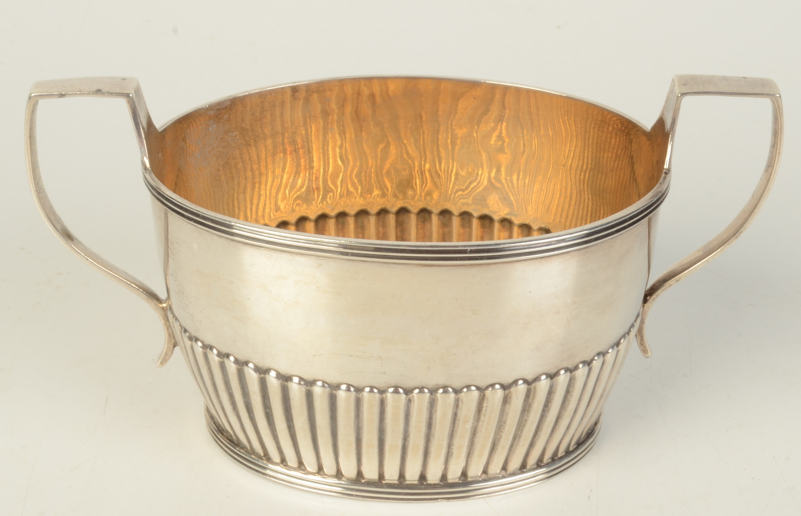 A half fluted twin handle small late Victorian silver sugar bowl, London 1890, 3.1oz.