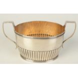 A half fluted twin handle small late Victorian silver sugar bowl, London 1890, 3.1oz.