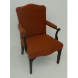 A George III Gainsborough armchair, with padded back, arm rests and seat on square, tapering,