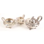 A ornate three piece silver service with floral and acanthus repousse decoration comprising a