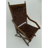 A late Victorian or Edwardian carpet upholstered deckchair.