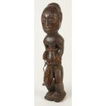 An African carved wood fertility figure of a man, height 51cm.
