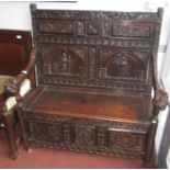 An ornately carved oak hall seat.