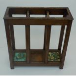 A mahogany umbrella stand, with three drip trays, two of these have later bird painted tiles,