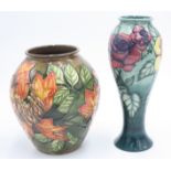 A slender modern Moorcroft vase, decorated with roses,