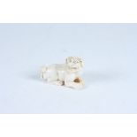 An ivory netsuke carved as a dog of fo, early 20th century, height 2.7cm, length 4.5cm.