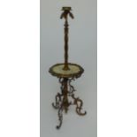 A gilt metal standard lamp, 20th century, with onyx shelf and curvilinear supports, height 148cm,