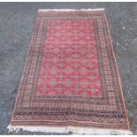 A Pakistan carpet, with eight rows of four octagonal guls, within multiple borders, 245 x 157cm.