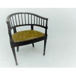 An Arts and Crafts ebonised tub armchair,