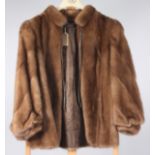 A light brown mink coat with leather neck tie, label inscribed 'R Danzig & Sons, London',