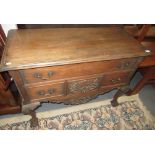 A George III style mahogany chest of drawers, the single long drawer above three short drawers,