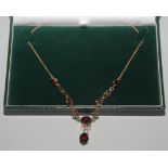 A gold and garnet set necklace.