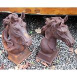 A pair of cast iron horse head finials.