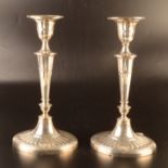 A pair of William Hutton late Victorian candlesticks in Adam style with bats wing fluting and oval