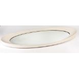 A Clark Eaton white painted oval wall mirror, mid 20th century, with original paper label, 96 x 36.