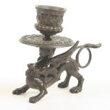 A bronze chamber candlestick, circa 1900, in the form of a winged beast, height 9.