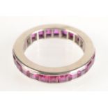 A very high purity white gold eternity ring calibre set with rubies.