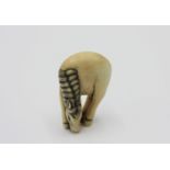 A ivory netsuke carved as a horse, early 20th century, height 3.8cm, width 2.7cm.